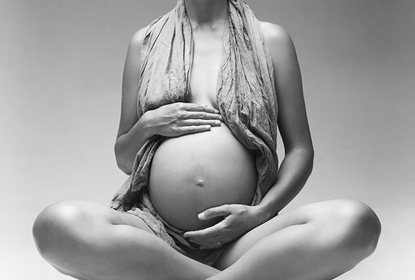 Young pretty pregnant woman in studio